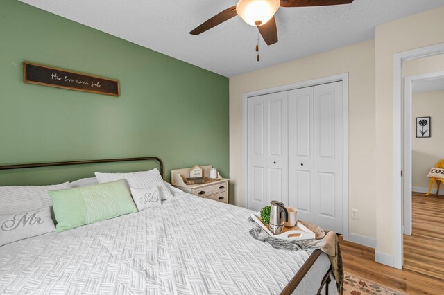 783 Park Brook Rd NW, Isanti, MN 55040 - bedroom with a closet, wood finished floors, baseboards, and ceiling fan