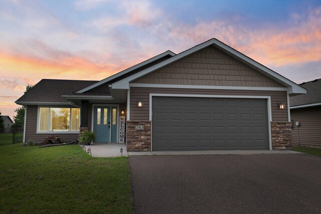 783 Park Brook Rd NW, Isanti, MN 55040 - craftsman-style house with stone siding, a garage, asphalt driveway, and a lawn