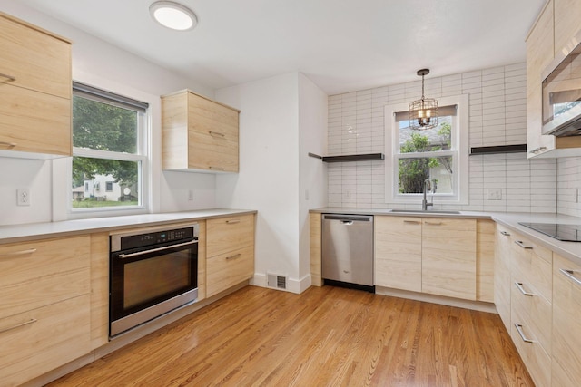 7417 Colfax Ave S, Richfield, MN 55423 - kitchen with stainless steel appliances, light brown cabinets, a sink, and modern cabinets