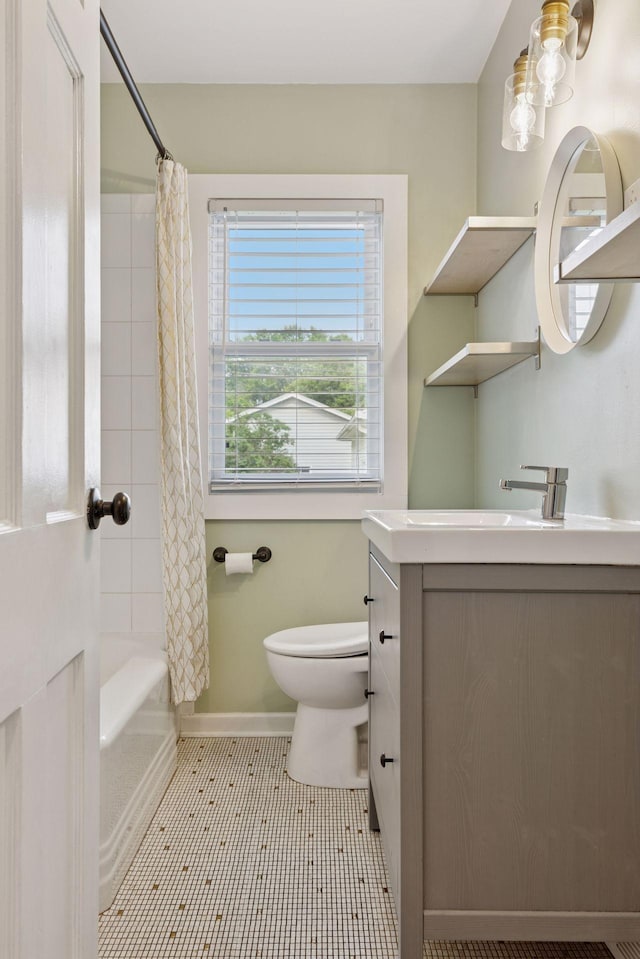 7417 Colfax Ave S, Richfield, MN 55423 - full bath featuring vanity, toilet, shower / tub combo with curtain, baseboards, and tile patterned floors