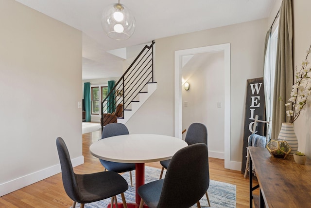7417 Colfax Ave S, Richfield, MN 55423 - dining room featuring light wood-style flooring, baseboards, and stairs