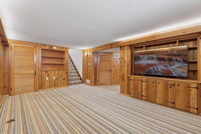 7417 Colfax Ave S, Richfield, MN 55423 - unfurnished living room featuring wooden walls, carpet flooring, and stairway