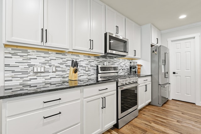 1884 Alexander Rd NE, Rochester, MN 55906 - kitchen with appliances with stainless steel finishes, white cabinetry, crown molding, dark stone countertops, and tasteful backsplash