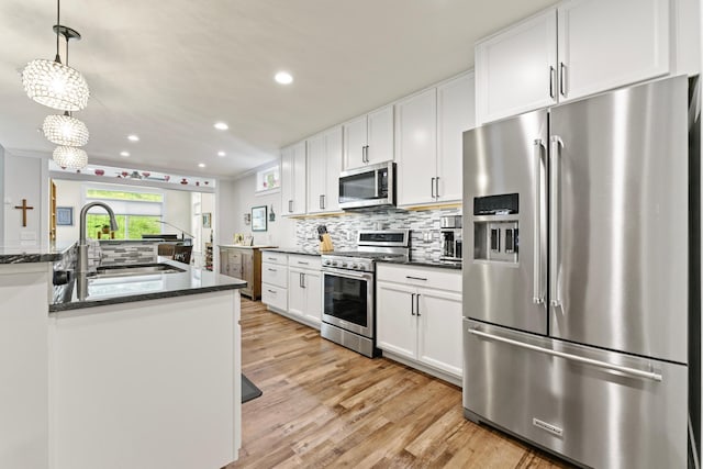 1884 Alexander Rd NE, Rochester, MN 55906 - kitchen featuring appliances with stainless steel finishes, a sink, backsplash, white cabinetry, and recessed lighting