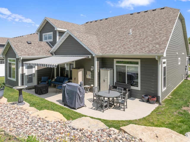 1884 Alexander Rd NE, Rochester, MN 55906 - rear view of property with a patio area, an outdoor hangout area, and a shingled roof