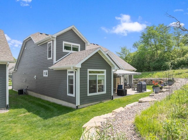 1884 Alexander Rd NE, Rochester, MN 55906 - back of property featuring a patio area, roof with shingles, a lawn, and central air condition unit