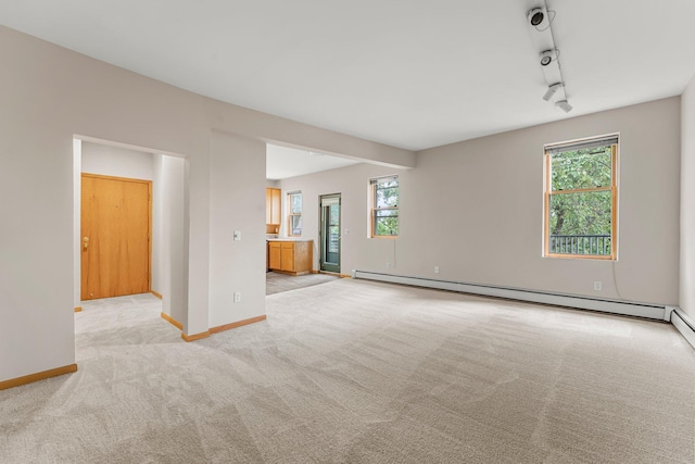 546 Laurel Ave Unit 6, Saint Paul, MN 55102 - unfurnished living room featuring light colored carpet, healthy amount of natural light, baseboard heating, and baseboards