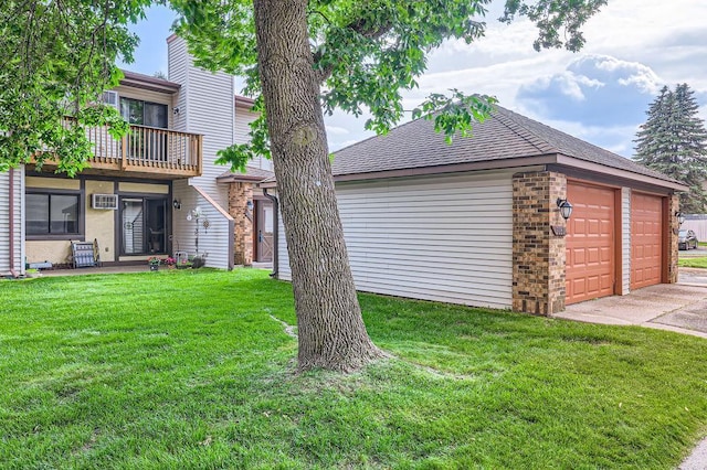2060 Pathways Dr Unit 13, Saint Paul, MN 55119 - view of grassy yard with a balcony, a detached garage, and an AC wall unit