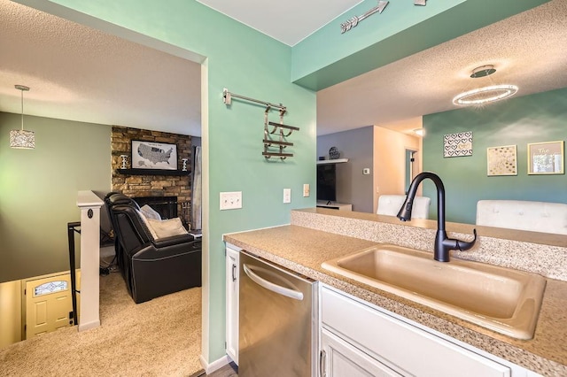 2060 Pathways Dr Unit 13, Saint Paul, MN 55119 - kitchen featuring a sink, stainless steel dishwasher, white cabinetry, a textured ceiling, and carpet floors