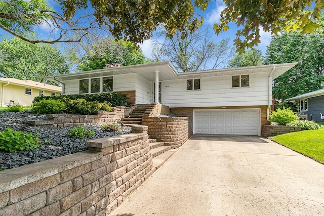 5313 Birchcrest Dr, Edina, MN 55436 - view of front of property featuring a garage, concrete driveway, a chimney, and brick siding