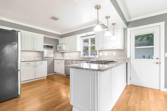 5313 Birchcrest Dr, Edina, MN 55436 - kitchen with appliances with stainless steel finishes, a peninsula, light wood-style flooring, white cabinetry, and ornamental molding