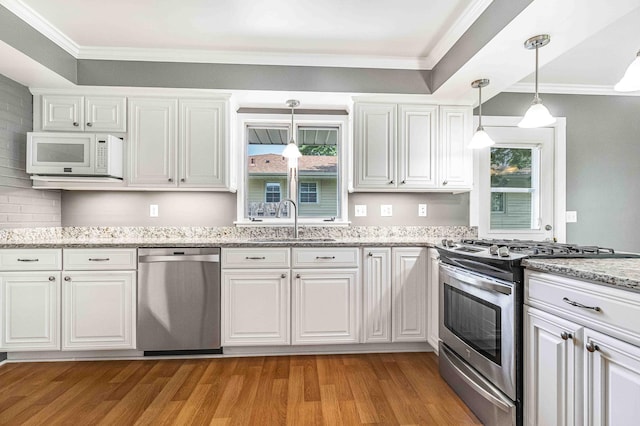 5313 Birchcrest Dr, Edina, MN 55436 - kitchen featuring stainless steel appliances, a sink, light wood-type flooring, ornamental molding, and white cabinets