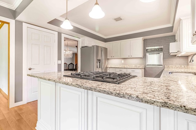 5313 Birchcrest Dr, Edina, MN 55436 - kitchen featuring stainless steel fridge, gas stovetop, a sink, light wood finished floors, and white cabinets