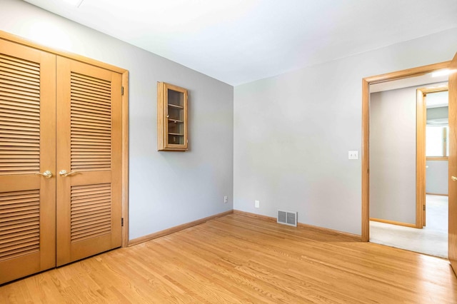 5313 Birchcrest Dr, Edina, MN 55436 - unfurnished bedroom with light wood-style flooring, a closet, and baseboards