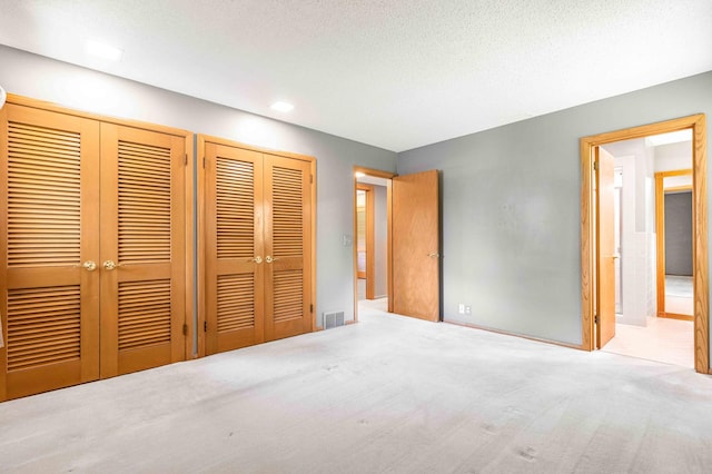 5313 Birchcrest Dr, Edina, MN 55436 - unfurnished bedroom featuring two closets, carpet, recessed lighting, and a textured ceiling