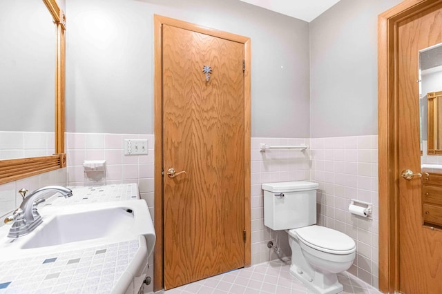 5313 Birchcrest Dr, Edina, MN 55436 - bathroom with tile walls, toilet, vanity, a wainscoted wall, and tile patterned flooring