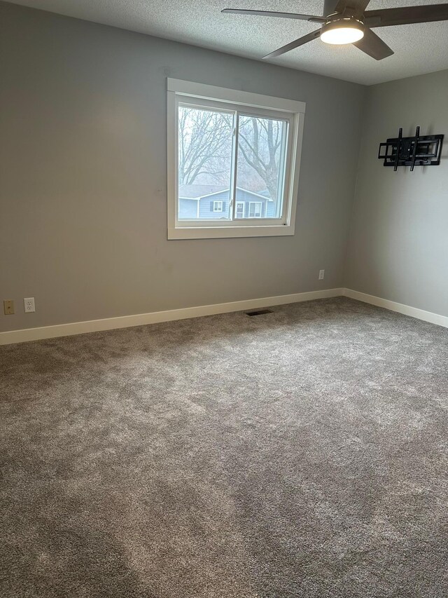 1911 Johnson St, Albert Lea, MN 56007 - carpeted empty room featuring a ceiling fan and baseboards