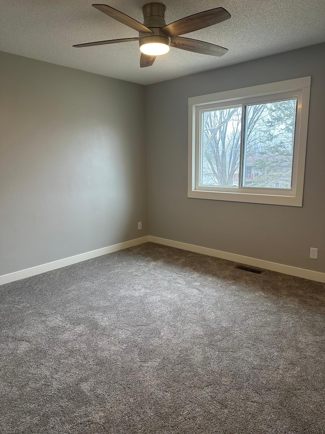 1911 Johnson St, Albert Lea, MN 56007 - carpeted spare room featuring a textured ceiling, ceiling fan, and baseboards