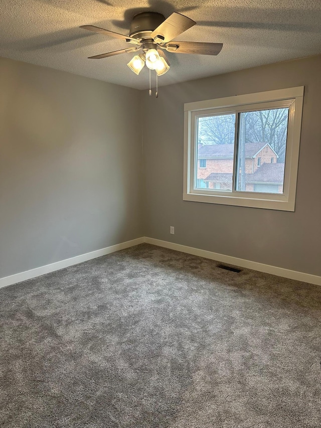 1911 Johnson St, Albert Lea, MN 56007 - unfurnished room featuring carpet, a ceiling fan, baseboards, and a textured ceiling