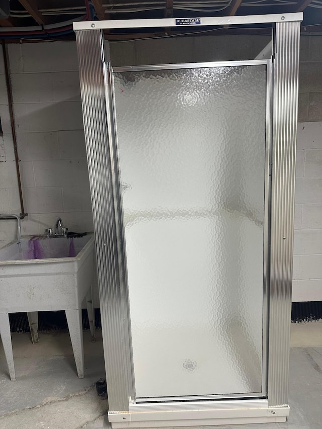 1911 Johnson St, Albert Lea, MN 56007 - full bathroom featuring a stall shower and unfinished concrete flooring