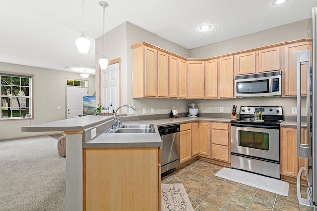 3537 Cherry Ln Unit C, Woodbury, MN 55129 - kitchen featuring appliances with stainless steel finishes, light brown cabinets, a peninsula, decorative light fixtures, and a textured ceiling