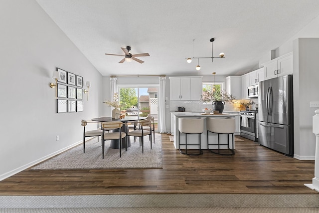 104 Bison Ct, Buffalo, MN 55313 - dining room with a ceiling fan, dark wood-style floors, and lofted ceiling