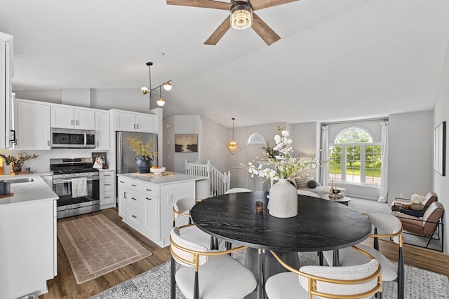 104 Bison Ct, Buffalo, MN 55313 - dining room with vaulted ceiling, dark wood-style floors, and ceiling fan