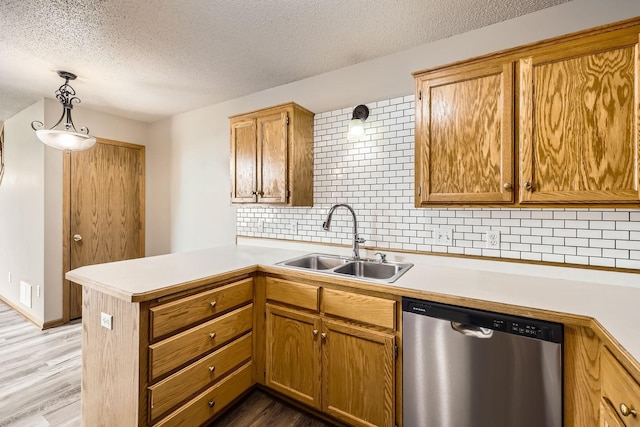 1127 Ridgestone Pl, Buffalo, MN 55313 - kitchen featuring stainless steel dishwasher, a peninsula, a textured ceiling, light countertops, and decorative backsplash