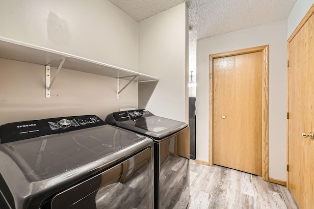 1127 Ridgestone Pl, Buffalo, MN 55313 - laundry area featuring light wood-style floors, washer and dryer, and a textured ceiling