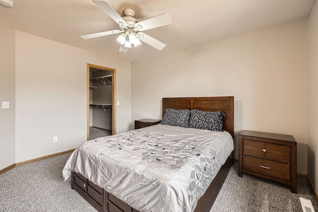 1127 Ridgestone Pl, Buffalo, MN 55313 - bedroom featuring carpet flooring, ceiling fan, a walk in closet, and a closet