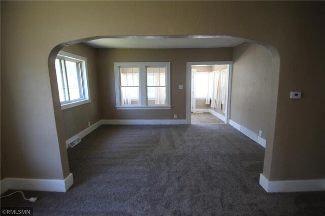 132 4th Ave N, Waite Park, MN 56387 - empty room featuring arched walkways, carpet flooring, and baseboards