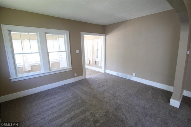 132 4th Ave N, Waite Park, MN 56387 - carpeted empty room with arched walkways and baseboards