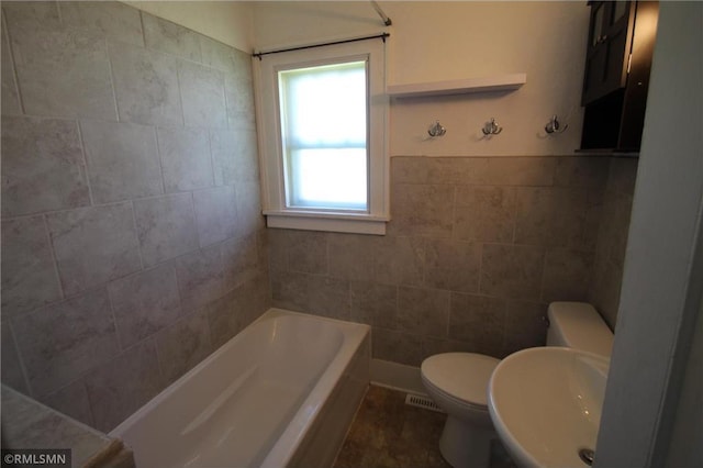 132 4th Ave N, Waite Park, MN 56387 - full bathroom with toilet, a tub, and tile walls