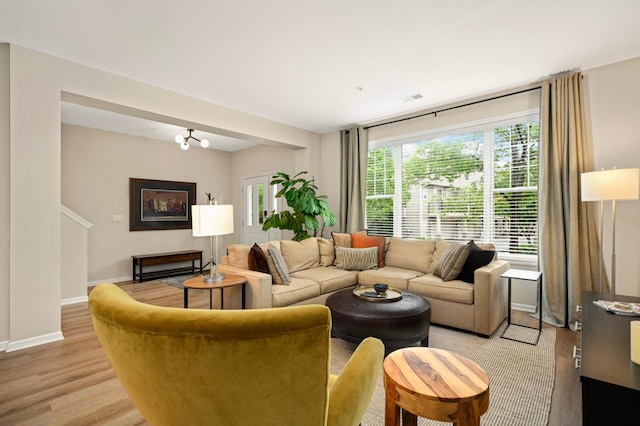 11275 Preswick Blvd, Eden Prairie, MN 55344 - living room featuring healthy amount of natural light, light wood finished floors, and baseboards