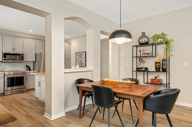 11275 Preswick Blvd, Eden Prairie, MN 55344 - dining area with light wood-type flooring, arched walkways, baseboards, and recessed lighting