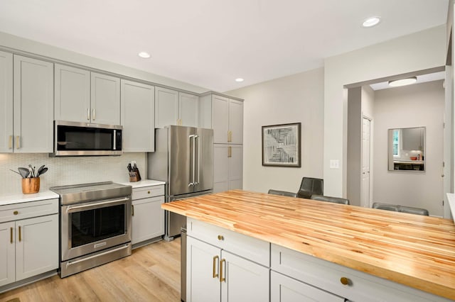 11275 Preswick Blvd, Eden Prairie, MN 55344 - kitchen featuring appliances with stainless steel finishes, butcher block counters, gray cabinets, backsplash, and light wood-style flooring