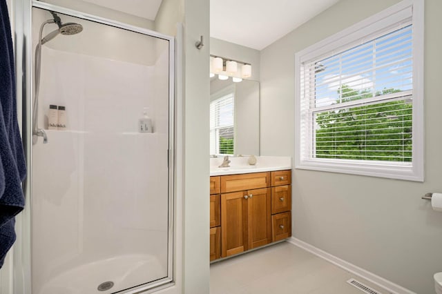 11275 Preswick Blvd, Eden Prairie, MN 55344 - bathroom with a stall shower, vanity, baseboards, and tile patterned floors
