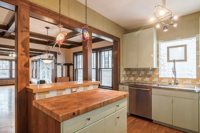 2545 Bryant Ave S Unit 1, Minneapolis, MN 55405 - kitchen with stainless steel dishwasher, wooden counters, wood finished floors, decorative backsplash, and hanging light fixtures