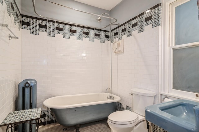 2545 Bryant Ave S Unit 1, Minneapolis, MN 55405 - bathroom featuring tile walls, a soaking tub, a shower, and tile patterned floors