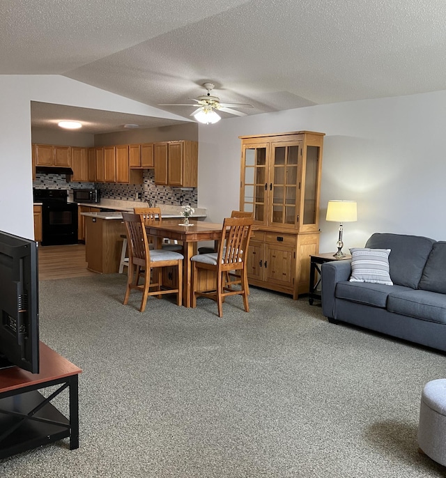 1332D Carriage Dr, Hudson, WI 54016 - dining area featuring light carpet, ceiling fan, and vaulted ceiling