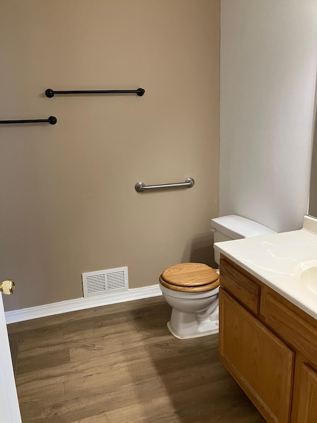 1332D Carriage Dr, Hudson, WI 54016 - bathroom featuring vanity, toilet, wood finished floors, and baseboards