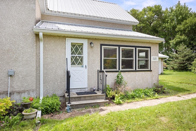 35746 585th Ave, Lafayette, MN 56054 - property entrance featuring stucco siding, a lawn, and a metal roof