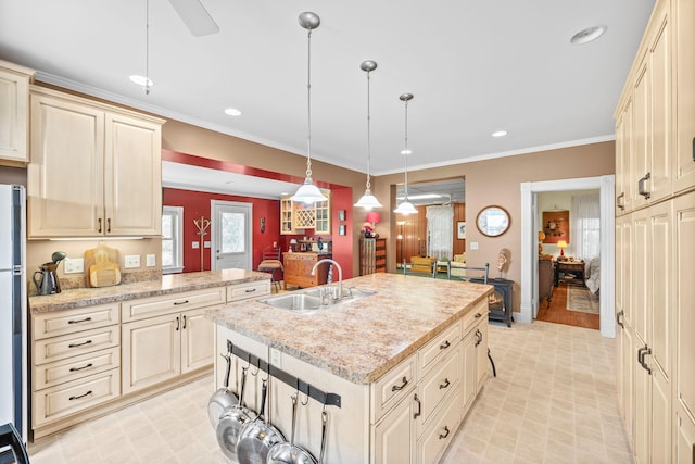 35746 585th Ave, Lafayette, MN 56054 - kitchen with cream cabinets, an island with sink, pendant lighting, recessed lighting, and ornamental molding