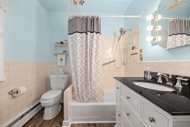 35746 585th Ave, Lafayette, MN 56054 - full bath featuring a baseboard heating unit, tile walls, vanity, shower / bath combo with shower curtain, and wainscoting