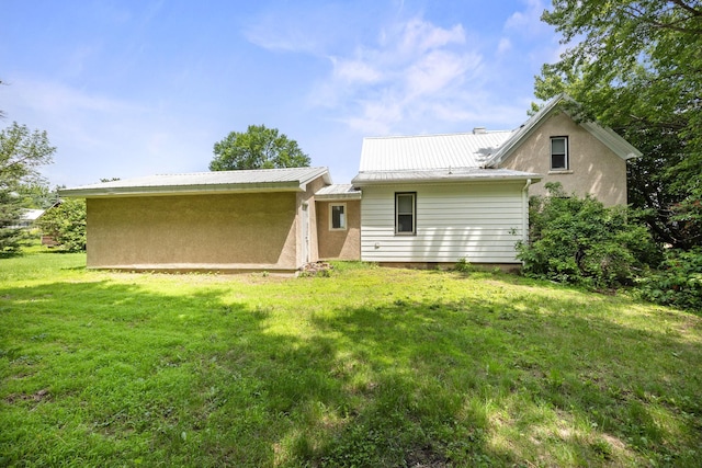 35746 585th Ave, Lafayette, MN 56054 - back of property featuring a lawn, a metal roof, and stucco siding