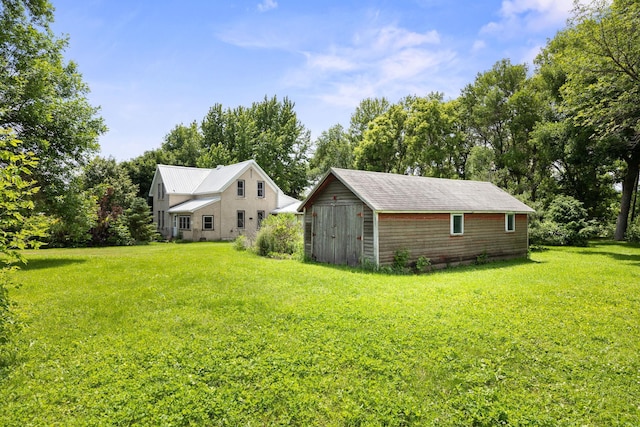 35746 585th Ave, Lafayette, MN 56054 - view of green lawn featuring a storage unit and view of wooded area