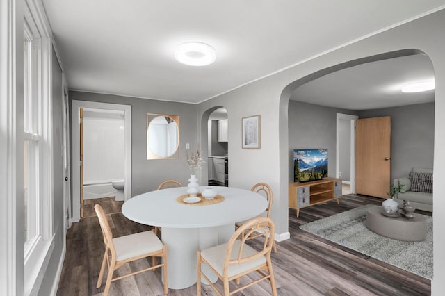414 Western Ln, Anoka, MN 55303 - dining area with arched walkways, dark wood-style flooring, and baseboards