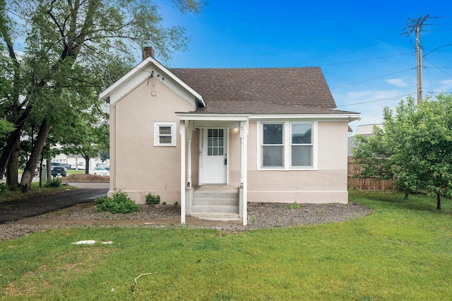 414 Western Ln, Anoka, MN 55303 - view of front of home featuring roof with shingles, a chimney, and stucco siding