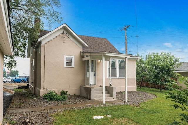 414 Western Ln, Anoka, MN 55303 - bungalow-style home featuring a shingled roof and stucco siding