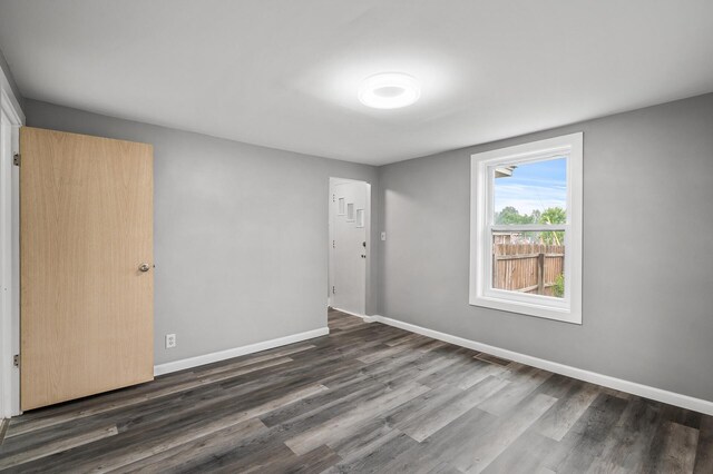 414 Western Ln, Anoka, MN 55303 - spare room featuring dark wood-type flooring and baseboards